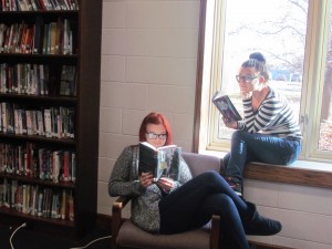 Candyce Magill and Jennifer Butler, seniors at LCHS, intently read their books in the library. 