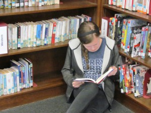 Halle Arnold, a senior at LCHS, curls up in the corner with a good book.
