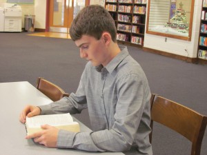 John Uthoff, junior at LCHS, rereads part of a good book.