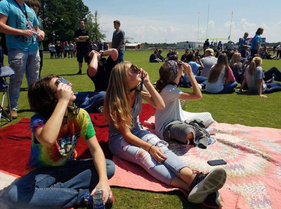 students watch eclipse